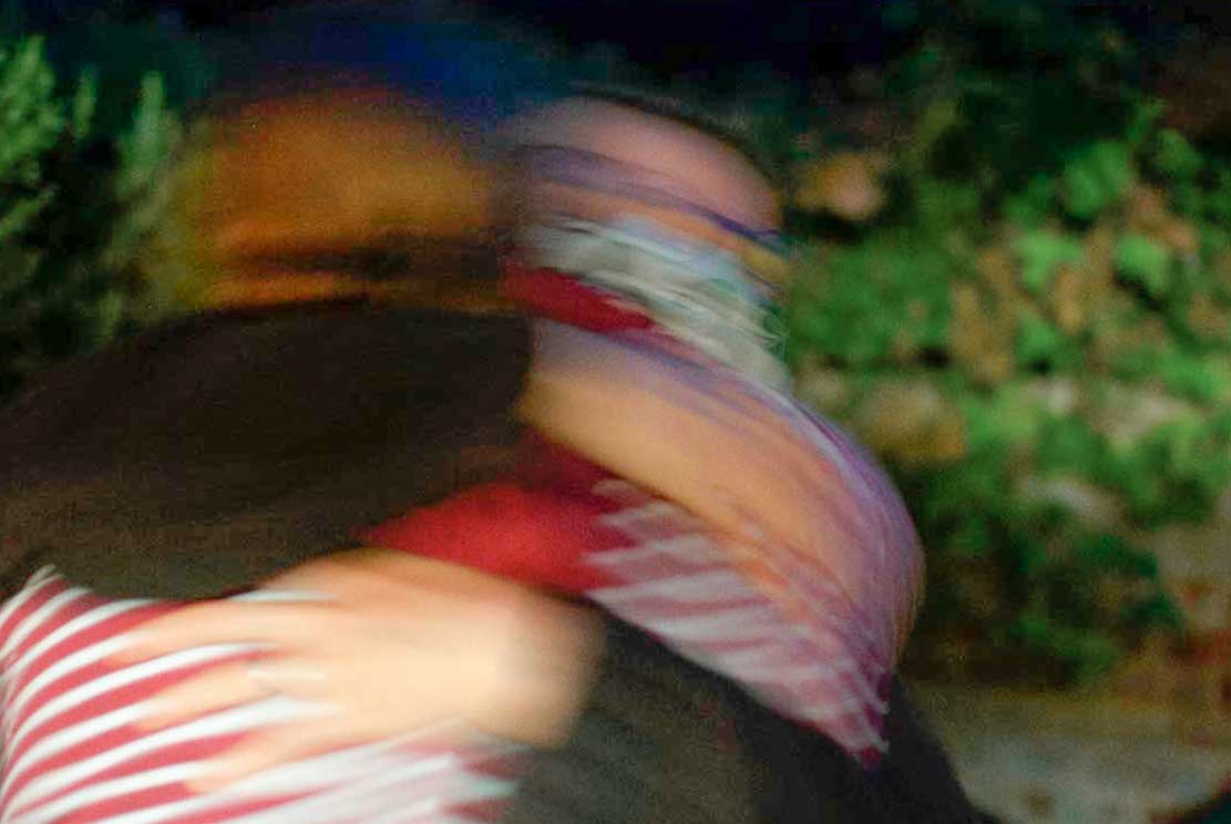 two friends hugging each other intensely while saying farewell 