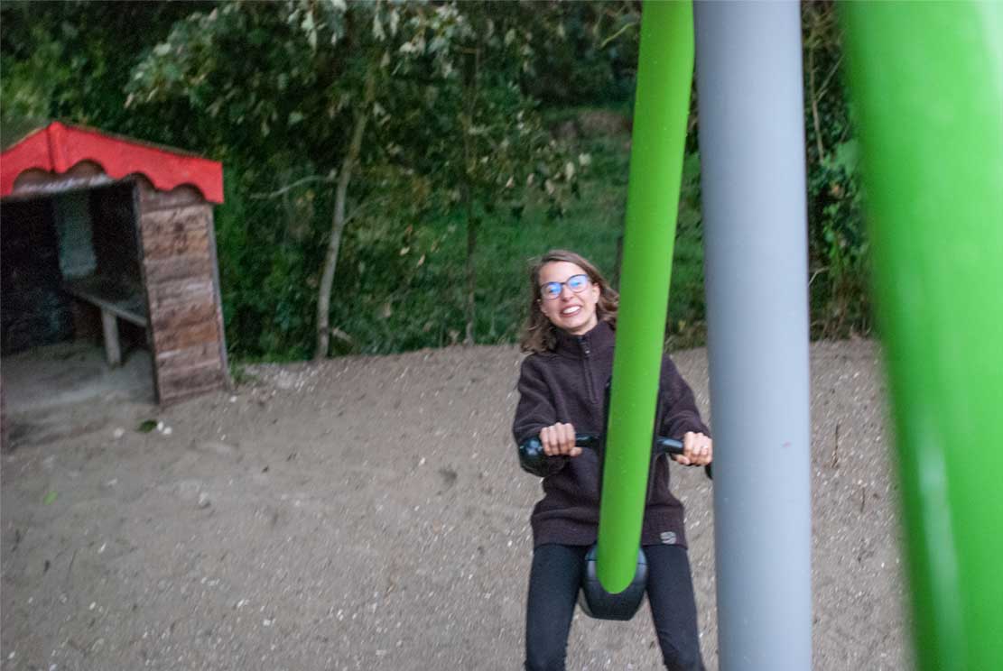 Meline laughing on a huge seesaw while me taking photo from the other side